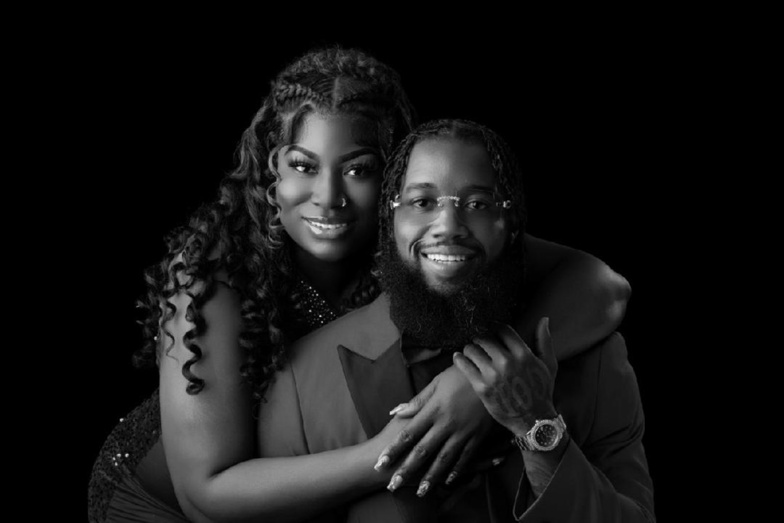 Kevin and Juanita smiling together in their engagement portrait